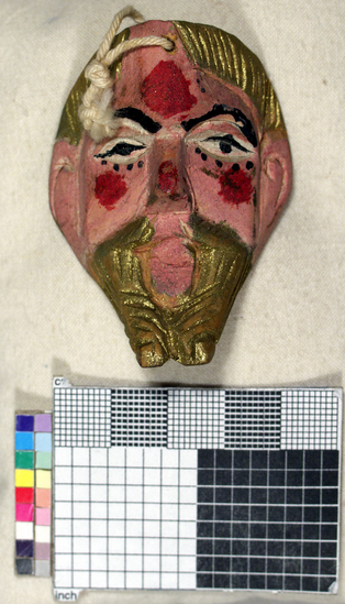 Hearst Museum object titled Toy mask, accession number 3-15587, described as Carved wooden toy mask; painted pink face