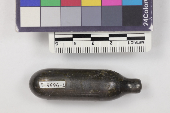 Hearst Museum object titled Corkscrew, accession number 7-9656l, described as Wine bottle cork ejector, carbon dioxide gas activated made of steel, plastic, carbon dioxide gas, cardboard, die forming, machining, and printing. a-d) cork ejector for wine bottle, carbon dioxide gas activated four part; a) white plastic-enclosed metal cylinder puncture mechanism at one end, black plastic spring loaded trigger at other end;  b) white plastic tubular chamber for gas cylinder, female threaded at one end, stainless steel cannula with fine hole at tip at other end; c) stainless steel carbon dioxide storage cylinder, punctured d) black plastic sheath for cannula e) Carton, cardboard, two piece for above; red marbleized finish, gilt-like printing, "Sparklets Corkmaster",  f-l) stainless steel carbon dioxide cylinders (7) unused m) carton, cardboard, for extra cylinder, white with blue lettering, "Sparkletts...bulbs...trademark... made in England...".