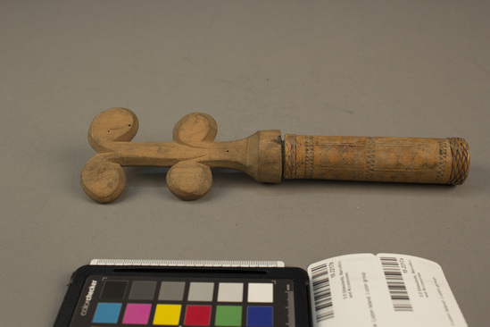 Hearst Museum object 2 of 2 titled Lime container and stopper, accession number 10-2217a,b, described as A) Bamboo lime container; incised geometric designs, band of plaited rattan around each end; 4⅝ inches long B) Large wood stopper; double headdress design; 5¼ inches long.