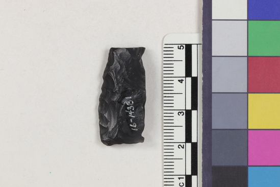 Hearst Museum object 2 of 2 titled Flake fragment, accession number 16-14381, described as Projectile point fragment; obsidian; triangular; weight: 3.31 grams; length: 1.5 cm; width: 3.0 cm; depth: 0.64 cm.