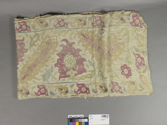 Hearst Museum object titled Bed valance, accession number 9-15036, described as Bed valance.  Linen, silk.  Plain weave, embroidered.  Natural ground, and varicolored designs.  Floral, foliage motives.  72 inches by 12 inches.