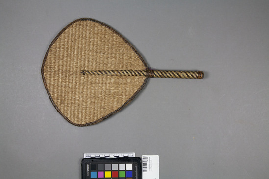 Hearst Museum object 1 of 2 titled Fan, accession number 10-2009, described as Fiber fan; leaf shape; plain and twill plaiting, handle wrapped with nito strips; 13¼ inches long