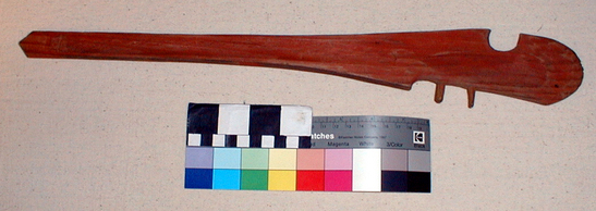 Hearst Museum object titled Spear-thrower, accession number 2-1818, described as Red and black stained cedar, single groove, two wood pegs.