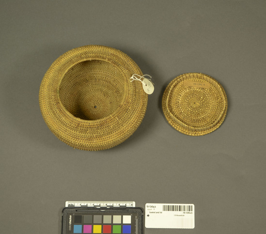 Hearst Museum object titled Basket and lid, accession number 18-1345a,b, described as Basket, coiled with lid; round, squat. (a) Basket. Diameter 17 cm. (b) Lid. Diameter 11 cm. General purpose, household storage. Made in only one village in central Lombok.