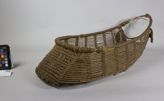 Hearst Museum object 2 of 2 titled Cradle, accession number 1-9462, described as Baby basket; twined. Warp and weft are peeled Hazel (Corylus cornuta californica). Rim of many slender hazel shoots bound with shreddy grape?