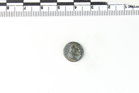 Hearst Museum object 6 of 6 titled Coin: æ, accession number 8-8080, described as Coin. Bronze, 12 mm. diameter, 1.9 grams. Obverse: Head facing left. Reverse: [untranscribable symbols with letters].