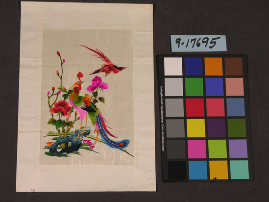 Hearst Museum object titled Textile, accession number 9-17695, described as Embroidery:  white silk satin worked w/ multicolor silk floss in bright hues; male & female phoenix in fantasy landscape w/ peonies.  White paper mount.  Mount stamped w/ "Hung Tai Dealers of Embroidery CO. #4 Lyndhurst Terrace, Hong Kong".  Made for toursit trade, brought by refugees from Shanghai.  42.6 cm L. w/ mount.