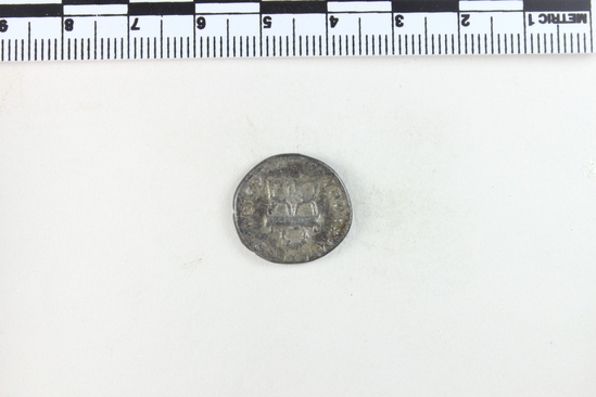 Hearst Museum object 7 of 8 titled Coin: æ denarius, accession number 8-5928, described as Coin: Denarius; (AR?) Æ; Titus - 2.56 grams. Rome, 80 AD. Obverse: IMP TITVS CAES VESPASIAN AVG PM - head laureate facing right. Reverse: TRP IX IMP XV COS JIII [line over the III] PP - Curule chair above which is a wreath.