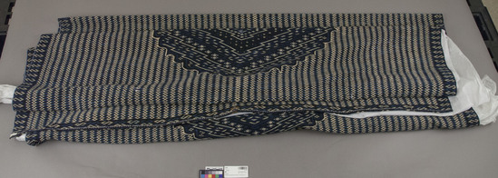 Hearst Museum object titled Serape, accession number 3-2384, described as Sarape, diamond decor, wool. Length 92 inches, width 61 inches (one piece). Warp 15-16, weft 68-96. Colors: blues predominating. Dark blue, two medium blues and white in the mosaic; an additional pale blue in the border and center. Light brown used only in motif at center of end border. Stylistically “The circular medallion having the concentric diamond organization.”