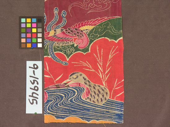 Hearst Museum object titled Textile fragment, accession number 9-15945, described as Paper back strip of cotton and paper. Plain weave, stencil reserve dyed. Varicolored with birds, water, and plat motifs. 13 3/4" x 7 1/4