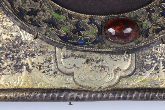 Hearst Museum object 17 of 49 titled Icon, accession number 7-3541, described as Icon of “Our lady of Vladmir”; Virgin and Child in tempera and gesso on wood; gilded silver basma; cloisonne halo with cloisonne collar pendant; halo has glass and amber (?) ornamentation; Virgin’s face damaged; height 30.2 cm, width 26 cm.