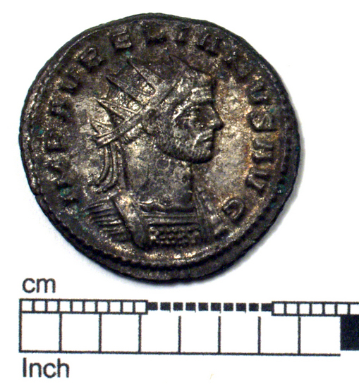 Hearst Museum object titled Coin: billon antoninianus, accession number 8-4049, described as Coin; AG; Billon. Antoninianus; Roman. 3.97 grams, 23 mm. Aurelian, 270-275 AD. Obverse: IMP AVRELIANVS AVG, Bust r. radiate. Reverse: ORIENS AVG, Sol striding r., foot on fallen foe; Z in field l., in exergue XXIR