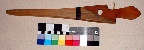 Hearst Museum object titled Spear-thrower, accession number 2-1817, described as Conifer with red stain at handle end, traces of black stain on remainder, black stripe. 1 antler peg