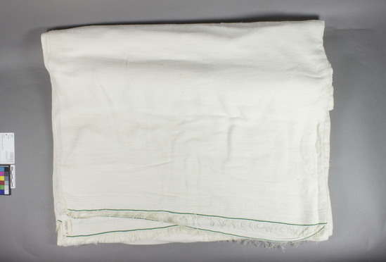 Hearst Museum object titled Shawl, accession number 5-16821, described as man's cotton shawl, 2 double thickness panels stitched together, finished with 14 narrow white-on-white bands and a narrow green band, and short fringes on each end.