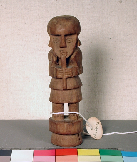 Hearst Museum object titled Figure, accession number 16-20457, described as Chimu style figure. Carved wooden standing figure playing flute.