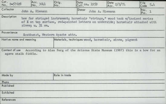 Documentation associated with Hearst Museum object titled Musical bow, accession number 2-57628, described as Horsehair "strings", wood back with incised series of X's on top surface, red-painted letters on underside; horsehair attached with sinew.