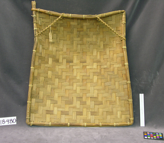 Hearst Museum object titled Winnower, accession number 18-480, described as Rice winnower in twill plaiting; two plaited inner handles. Made by men, used by women and girls. From Bali Gurah. 44 x 58 cm.