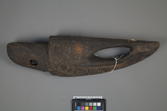 Hearst Museum object titled Canoe prow, accession number 11-37669, described as Canoe prow, carved wood, from a river canoe; stylized head of a crocodile with upturned snout; traces of red pigment in excised areas; 54.6 cm 1.