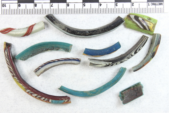 Hearst Museum object titled Bracelet fragments, glass, multicolored, accession number 5-1487, described as Glass bracelet broken pieces