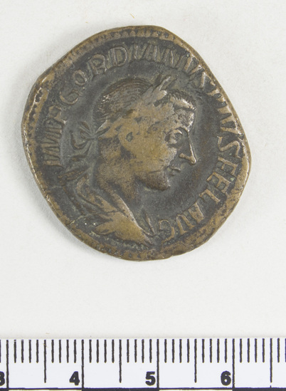 Hearst Museum object 4 of 8 titled Coin: æ sestertius, accession number 8-5921, described as Coin: Sestertius; Æ; Gordianus.Pius - 17.17 grams. Rome, 240-244 AD. Obverse: IMP GORDIANVS PIVS FEL AVG - bust facing right, laureate, draped, cuirassed. Reverse: FELICI T TEMPOR, SC - Felicitas standing holding long caduceus and cornucopiae.