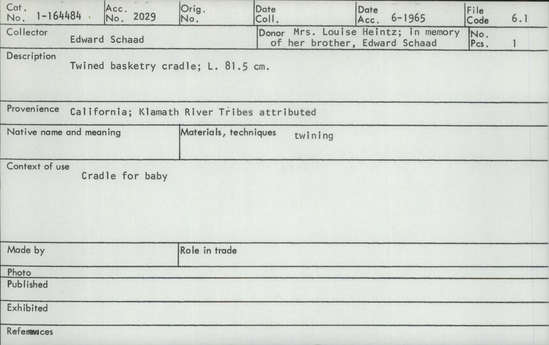 Documentation associated with Hearst Museum object titled Cradle, accession number 1-164484, described as Twined basketry.  Tag "Klamath R. Tribes Att.". Per Ralph Shanks:  Twined openwork baby basket.  The warp material is probably willow, possibly hazel.  The wefts are of uncertain material.  At the foot there is plain twining, spaced closer than the rest of the basket.  The rim is covered,  reinforced with rods.  Starting at the foot there are sets of three paired weft rows all the way to the handle.  The basket has alternating slants of weft twists, often switching by weft row.  The basket is from Northwestern California.