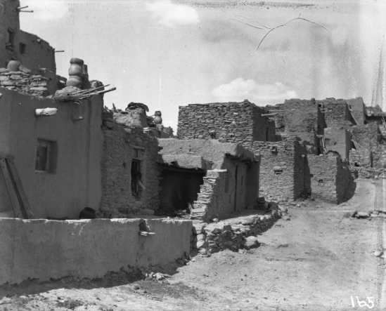 Hearst Museum object titled Black-and-white negative, accession number 15-165, described as View of a row of houses from the front; note chimneys made of pots