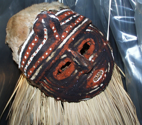 Hearst Museum object titled Mask and covering, accession number 5-2633, described as Makishi costume; barkcloth; complete; includes framework covered with beeswax and barkcloth; painted red and white; hoop frame around center covered with bark; held together with nusomba string; bark skirt.