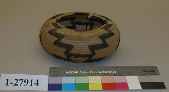 Hearst Museum object titled Basket, accession number 1-27914, described as Flattened, globose, single-rod coiled.  Black design.