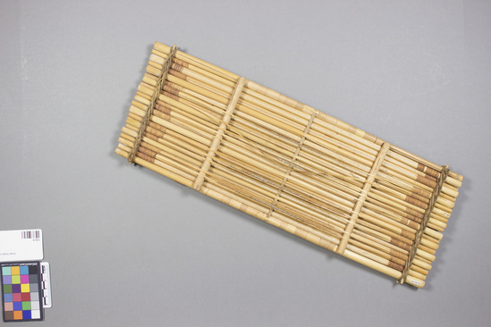 Hearst Museum object 1 of 2 titled Zither, accession number 5-7672, described as Zither, cane; a series of tied tules with stretched reeds which when plucked, create a sound. Length 42 cm, width 15 cm