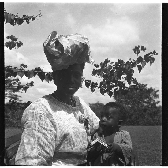 Hearst Museum object titled Black-and-white negative, accession number 15-31091, described as Black-and-white negative, Nigeria, Meko, Head tie (2) front and back, Mrs. M. with child, 1950-1951