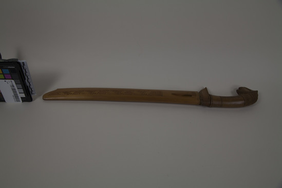 Hearst Museum object 4 of 5 titled Knife, accession number TEMP 2018.1415, described as Javanese parang knife, carved sheath and handle with animal head. overall 22" length.