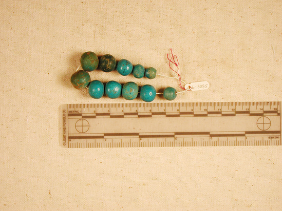 Hearst Museum object 1 of 3 titled Beads, accession number 6-13085, described as beads: string blue glaze spherical; length 13 cm