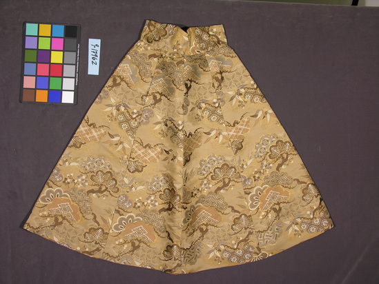 Hearst Museum object titled Skirt, accession number 9-17962, described as Skirt:  Western styling; gold, brown & grey silk, made from obi material embellished w/ metallic gold thread.  Pine, plum, cherry and bamboo design.  Machine sewn; wide waste band; excellent condition.  Circa 1930, fide Mary Hays.  L: 89.6 cm.