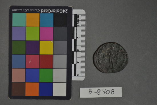 Hearst Museum object 6 of 7 titled Coin: æ, accession number 8-8408, described as Coin, Æ, in bag with other coins and note "Roman per John Smith 7/28/1976." Obverse: face in profile facing left with a garland on the hair. Around edge: ??PCCHLVHL; H; INIHNV????. Reverse: central standing figure holding fronds or a bouquet. Around edge: NIOPOPV; ??OM???.