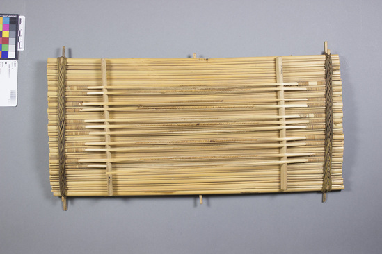 Hearst Museum object titled Zither, accession number 5-3031, described as Cane Zither; Yom Kwo; composed of a series of cane lashed together, "strings" made from split cane; pitch controlled by wrapping varying thicknesses of fiber around "strings".