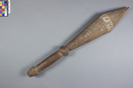 Hearst Museum object titled War club, accession number 11-37141, described as War club Tombi; red teak; typical of smaller sized war clubs, incised decoration with lined covering. 21 inches long.