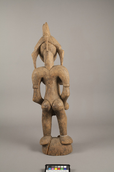 Hearst Museum object titled Figure, accession number 5-3294, described as Carved wooden figure. Standing female with hands around protruding umbilicum; incised lines on breasts, chest and face.H = 30.0”.