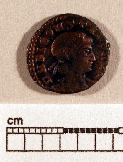 Hearst Museum object titled Coin: æ, accession number 8-8597, described as Coin; Æ 1.48 grams. 15 mm. Obverse: DNFL CONSTANS AVG - bust  facing right, diademed and draped. Reverse: GLORIA EXERCITUS- standard between two soldiers. Mint Data: Constans Italia -Rome.