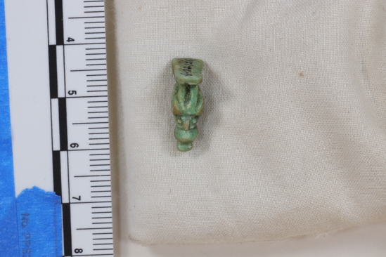 Hearst Museum object 3 of 13 titled Hawk amulet, accession number 6-22126, described as Amulet of hawk with one-handled peg on head; length 16 mm, greenish faience.