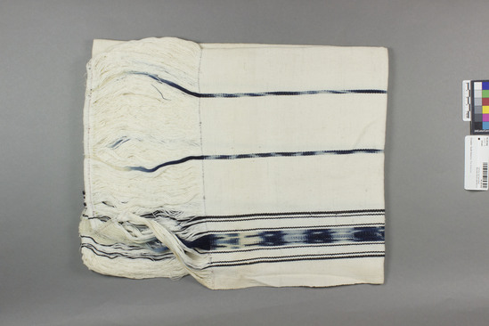 Hearst Museum object titled Shawl, accession number 16-20184, described as Shawl, woman’s; 134 x 65 cm, excluding fringe; fringe 17 cm still attached; white ground; multi striped in indigo; 2 borders have indigo stripes 7 cm,; 6 narrow stripes and one 2.25 cm stripe in middle of shawl.