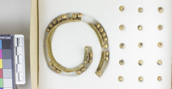 Hearst Museum object 2 of 6 titled Bracelet, accession number 4-2880, described as Gold bracelet consisting of band about ⅓ inches wide, to which 38 hollow gold beads were originally soldered. 22 of the beads remain in place. The bracelet is in 3 pieces