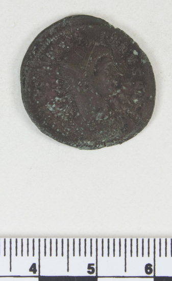 Hearst Museum object 6 of 8 titled Coin: billon antoninianus, accession number 8-4068, described as Coin; Billon; Antoninianus; Roman. 5.40 grams, 26 mm. Aurelian, 270-275 AD. Rome, Italy. Obverse: IMP C AVRELIANVS, Bust r. radiate. Reverse: ORIENS AVG, Sol l., between two captives, in exergue T M