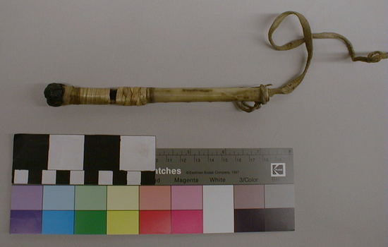 Hearst Museum object 3 of 4 titled Whistle, accession number 1-9304a,b, described as Bone, wrapped in natural color fiber in bands near center. Black mastic plug at distal end. (a) joined to (b) by leather thong.