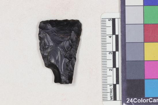 Hearst Museum object 1 of 2 titled Projectile point fragment, accession number 16-14330, described as Projectile point; obsidian fragment; triangular; weight: 7.07 grams; length: 3.98 cm; width: 2.65 cm; depth: 0.64 cm; straight sides; straight, thinned base.