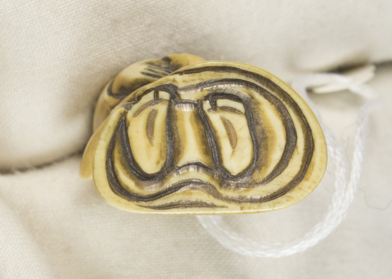 Hearst Museum object 9 of 12 titled Netsuke, accession number 9-18783, described as Netsuke; figure of man, standing, with long robe, flaring at feet; right hand holding robe, left hand concealed; H 6.0 cm X W 2.3 cm