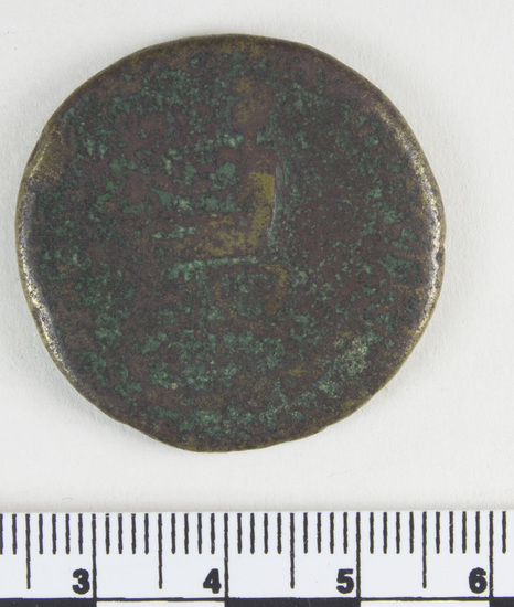 Hearst Museum object 6 of 7 titled Coin: æ sestertius, accession number 8-6484, described as Coin: Sestertius; Æ; Nero Claudius Drusus Ru. Claudius Standard. - 20.2 gm. Obverse: [NERO CLAVD]IVS GERMAN[ICVS IMP] - Bare head of Claudius, facing left. Reverse: Illegible - Claudius seated on a curule chair surrounded by weapons.