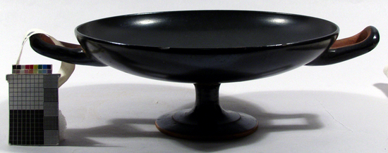 Hearst Museum object titled Shallow cup, accession number 8-3386, described as Attic B/G kylix; foot broken off and reset, small chips in rim; glaze has preserved very fine sheen; shape Type B: shallow bowl, foot in two degrees, hollow stem; handle-patches, verticle edge and ring break in profile of foot reserved; underfoot reserved with broad black ring; traces of coral-red beneath underhandles and underfoot