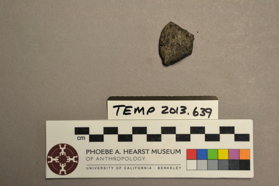 Hearst Museum object titled Baked clay, accession number TEMP 2013.639, described as Baked clay or asphalt fragment found with no label. Found in a bag with label "MRN 232  No cat #". No other information found.