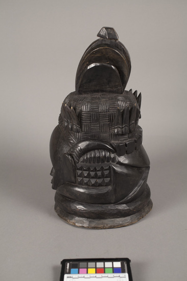 Hearst Museum object titled Helmet mask, accession number 5-5834, described as helmet mask of West African gum wood blackened with shoe polish; anthromorphic with elaborate headdress and horns; height 42 cm