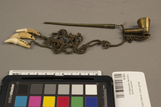 Hearst Museum object titled Pipe, accession number 10-832, described as Brass tobacco pipe with separable stem and attached brass chain with double spiral ornament and 3 dog tooth pendants